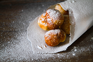 Serving of bunuelos covered in powdered sugar