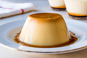 Image of a carmel custard on a plate.